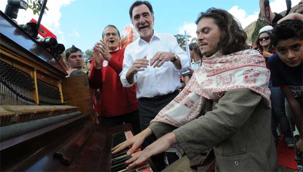 Patrus Ananias observa o músico Gabriel Guedes  tocando piano, na Praca do Papa, onde o candidato participou de um festival de pipas vermelhas  (Beto Novaes/EM/D.A Press)