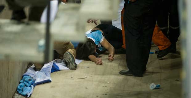 Torcedora � socorrida ap�s a grade de prote��o ceder (AFP PHOTO/AGIF/RAMIRO FURQUIM )