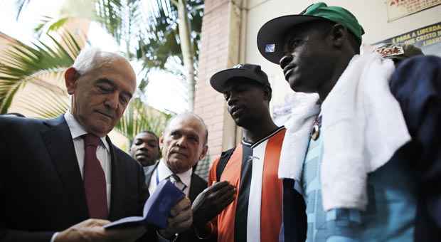Ministro do Trabalho Manoel Dias confere carteira de trabalho dada a haitiano, na igreja Nossa Senhara da Paz (Nacho Doce/Reuters) Ministro do Trabalho Manoel Dias confere carteira de trabalho dada a haitiano, na igreja Nossa Senhara da Paz (Nacho Doce/Reuters)